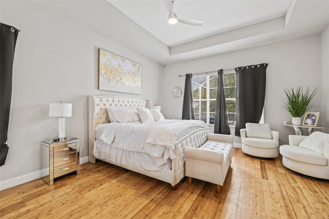 22623 Cliffside Way, Land O Lakes, FL 34639 - bedroom featuring light wood-type flooring, a raised ceiling, and ceiling fan