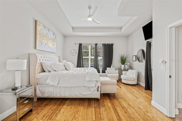 22623 Cliffside Way, Land O Lakes, FL 34639 - bedroom with a raised ceiling, light wood-style floors, and a ceiling fan