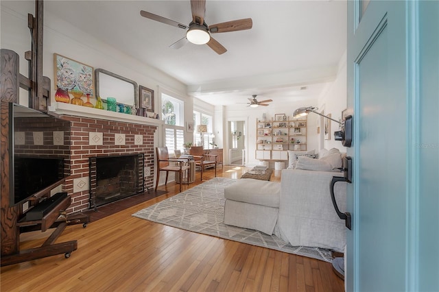 1407 S Moody Ave, Tampa, FL 33629 - living room featuring a ceiling fan, a brick fireplace, and wood-type flooring