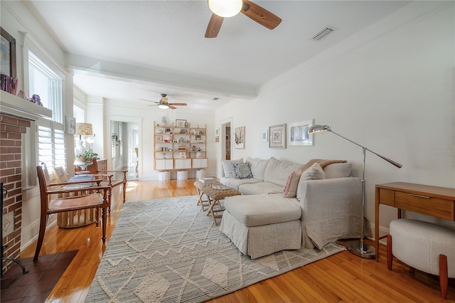 1407 S Moody Ave, Tampa, FL 33629 - living area featuring a ceiling fan, wood finished floors, a fireplace, and beamed ceiling