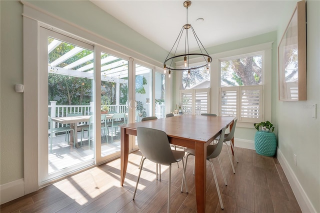 1407 S Moody Ave, Tampa, FL 33629 - dining room featuring plenty of natural light, wood finished floors, and a chandelier