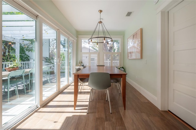 1407 S Moody Ave, Tampa, FL 33629 - dining room featuring a chandelier, plenty of natural light, and wood finished floors