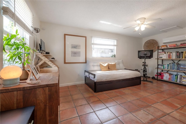 1407 S Moody Ave, Tampa, FL 33629 - bedroom featuring a wall unit AC, light tile patterned flooring, a textured ceiling, and a ceiling fan