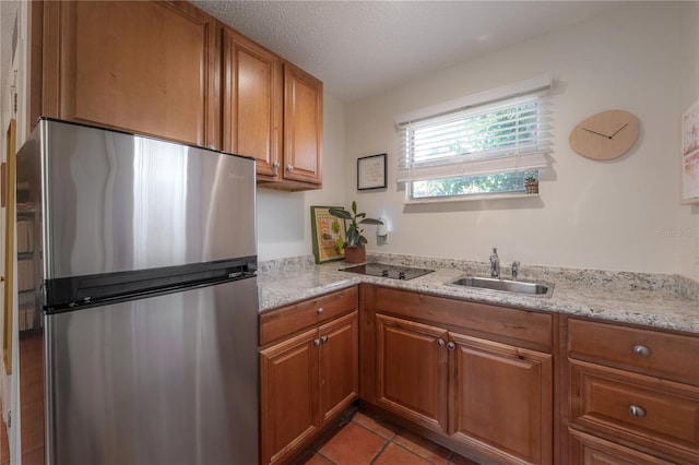 1407 S Moody Ave, Tampa, FL 33629 - kitchen featuring freestanding refrigerator, brown cabinetry, and light tile patterned floors