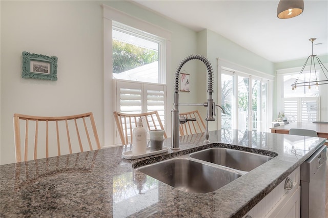 1407 S Moody Ave, Tampa, FL 33629 - kitchen featuring dishwasher, dark stone counters, pendant lighting, and a chandelier