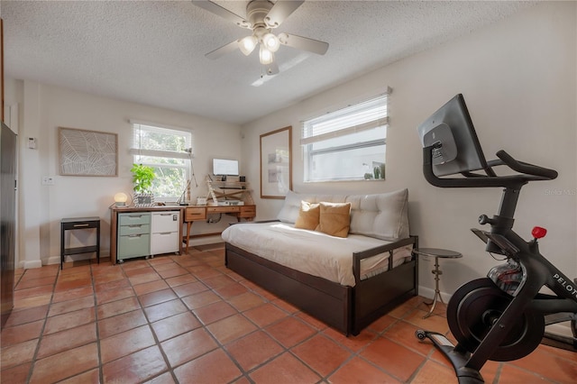 1407 S Moody Ave, Tampa, FL 33629 - bedroom with a textured ceiling, a desk, light tile patterned floors, and a ceiling fan