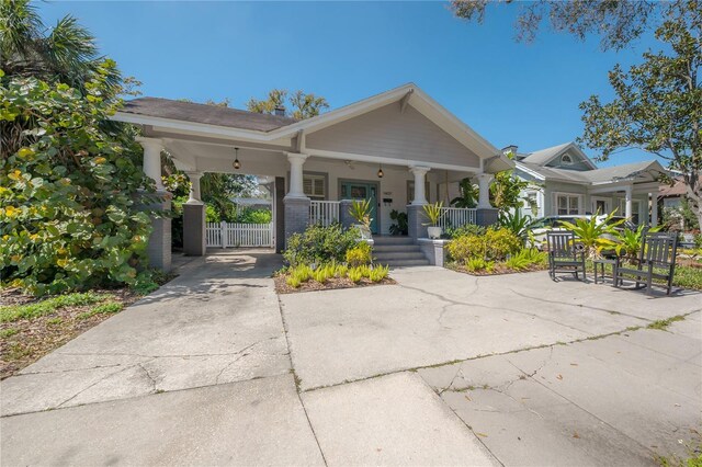 1407 S Moody Ave, Tampa, FL 33629 - craftsman inspired home with covered porch, concrete driveway, and an attached carport