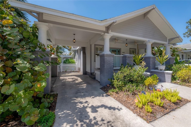 1407 S Moody Ave, Tampa, FL 33629 - view of side of home featuring covered porch, ceiling fan, and concrete driveway