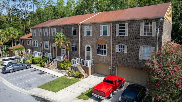 4117 Daventry Ln, Palm Harbor, FL 34685 - view of property featuring brick siding and an attached garage