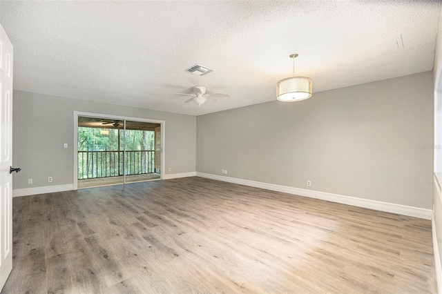4117 Daventry Ln, Palm Harbor, FL 34685 - empty room featuring a ceiling fan, wood finished floors, and a textured ceiling