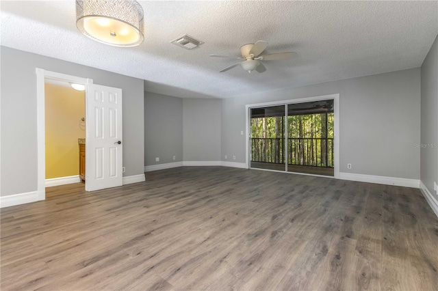 4117 Daventry Ln, Palm Harbor, FL 34685 - spare room featuring ceiling fan, a textured ceiling, and wood finished floors