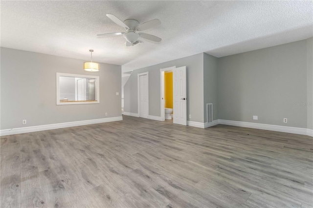 4117 Daventry Ln, Palm Harbor, FL 34685 - unfurnished room with a textured ceiling, wood finished floors, and ceiling fan