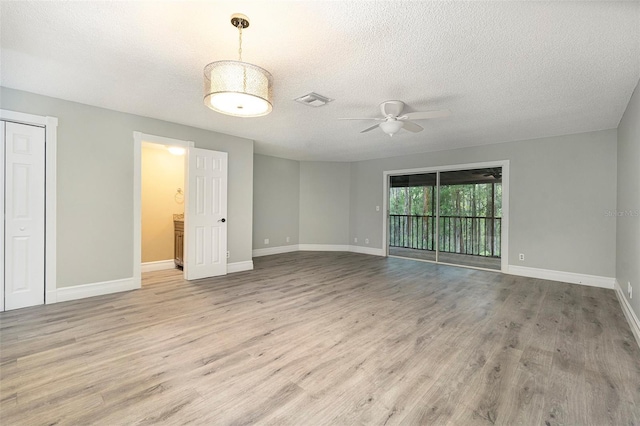 4117 Daventry Ln, Palm Harbor, FL 34685 - empty room with ceiling fan, wood finished floors, and a textured ceiling