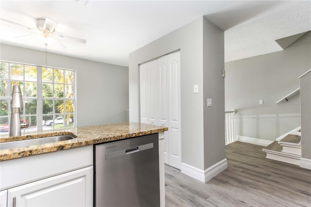 4117 Daventry Ln, Palm Harbor, FL 34685 - kitchen featuring dishwasher, light wood-type flooring, light stone countertops, a ceiling fan, and white cabinets