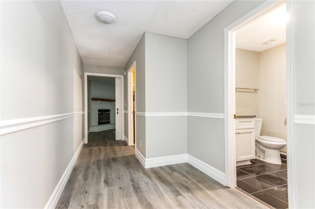 4117 Daventry Ln, Palm Harbor, FL 34685 - hall featuring wood finished floors and a textured ceiling