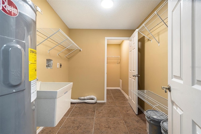 4117 Daventry Ln, Palm Harbor, FL 34685 - washroom featuring water heater, hookup for a washing machine, and tile patterned floors