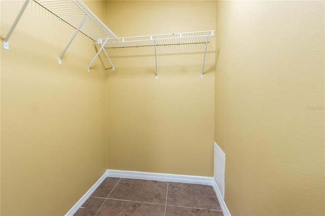4117 Daventry Ln, Palm Harbor, FL 34685 - spacious closet featuring dark tile patterned floors