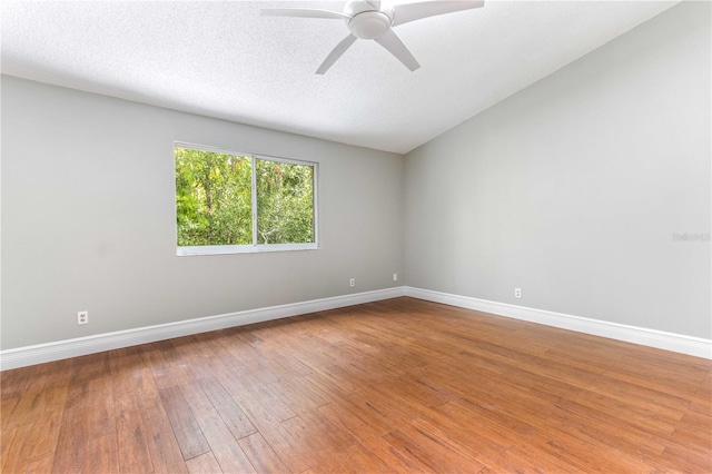 4117 Daventry Ln, Palm Harbor, FL 34685 - spare room with a ceiling fan, wood-type flooring, and vaulted ceiling