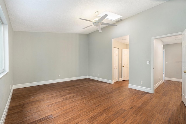4117 Daventry Ln, Palm Harbor, FL 34685 - empty room featuring ceiling fan, wood finished floors, lofted ceiling, a textured ceiling, and a skylight