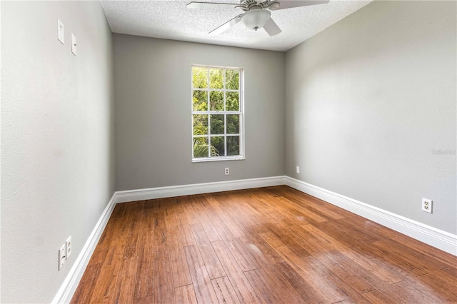 4117 Daventry Ln, Palm Harbor, FL 34685 - empty room with a ceiling fan, hardwood / wood-style floors, and a textured ceiling