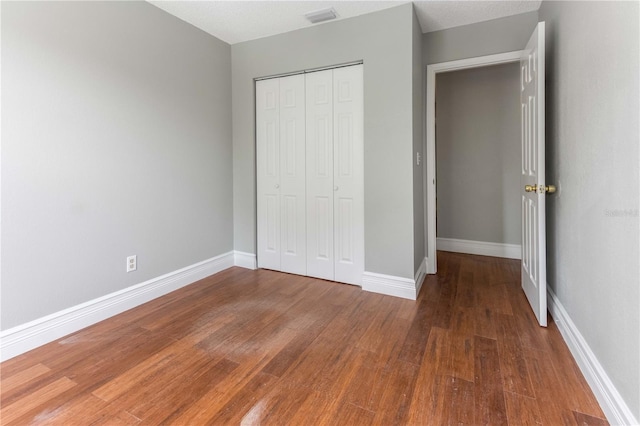 4117 Daventry Ln, Palm Harbor, FL 34685 - unfurnished bedroom with wood finished floors and a closet
