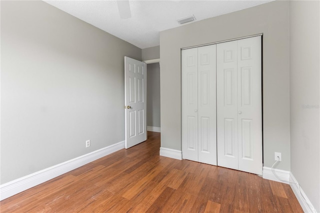 4117 Daventry Ln, Palm Harbor, FL 34685 - unfurnished bedroom featuring wood finished floors, a closet, and ceiling fan