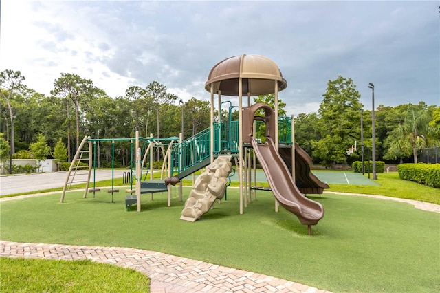 4117 Daventry Ln, Palm Harbor, FL 34685 - community play area featuring a lawn and view of wooded area
