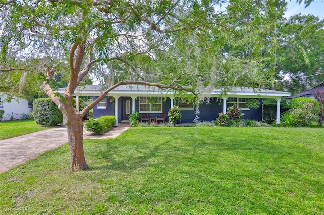 1708 Pond Lake Dr, Tampa, FL 33612 - single story home featuring a front lawn, driveway, and covered porch
