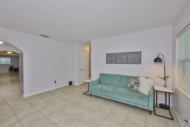 1708 Pond Lake Dr, Tampa, FL 33612 - living room featuring arched walkways and light tile patterned floors