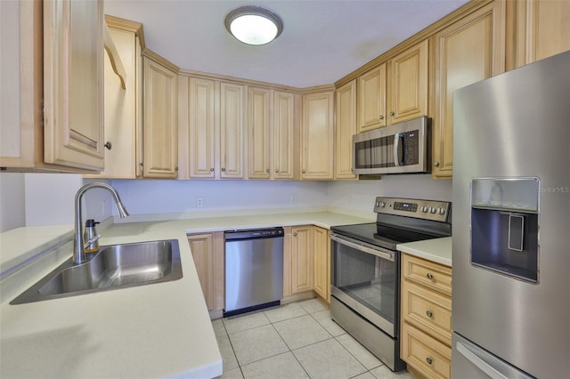 1708 Pond Lake Dr, Tampa, FL 33612 - kitchen with appliances with stainless steel finishes, light brown cabinetry, light tile patterned floors, and light countertops