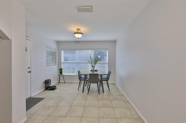 1708 Pond Lake Dr, Tampa, FL 33612 - dining area with baseboards and light tile patterned flooring