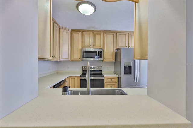 1708 Pond Lake Dr, Tampa, FL 33612 - kitchen with stainless steel appliances, light countertops, light brown cabinets, and a peninsula