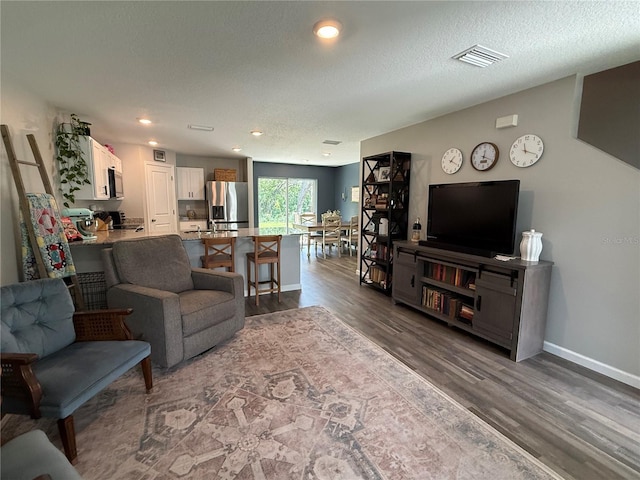6270 Airmont Dr, Spring Hill, FL 34606 - living room with dark wood-type flooring, recessed lighting, and a textured ceiling