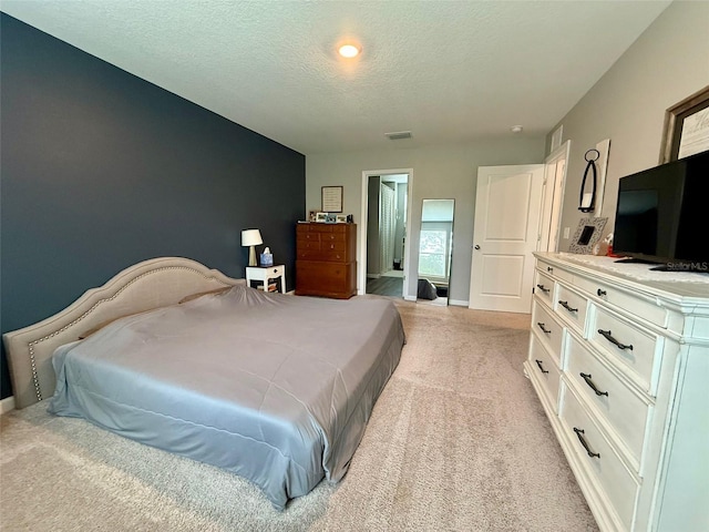 6270 Airmont Dr, Spring Hill, FL 34606 - bedroom with light colored carpet and a textured ceiling