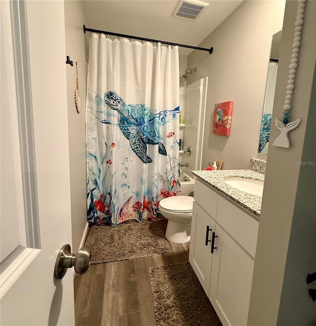 6270 Airmont Dr, Spring Hill, FL 34606 - full bathroom featuring wood finished floors, vanity, and shower / bath combination with curtain