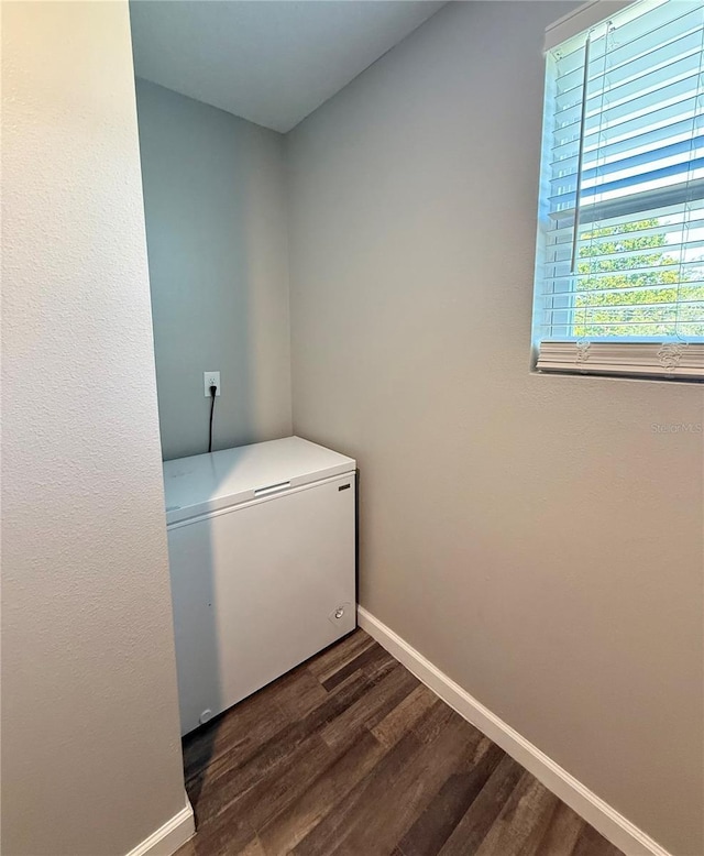 6270 Airmont Dr, Spring Hill, FL 34606 - washroom featuring baseboards and dark wood finished floors