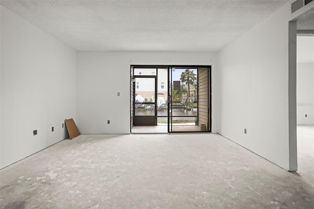 358 Moorings Cove Dr Unit 4B, Tarpon Springs, FL 34689 - empty room featuring a textured ceiling