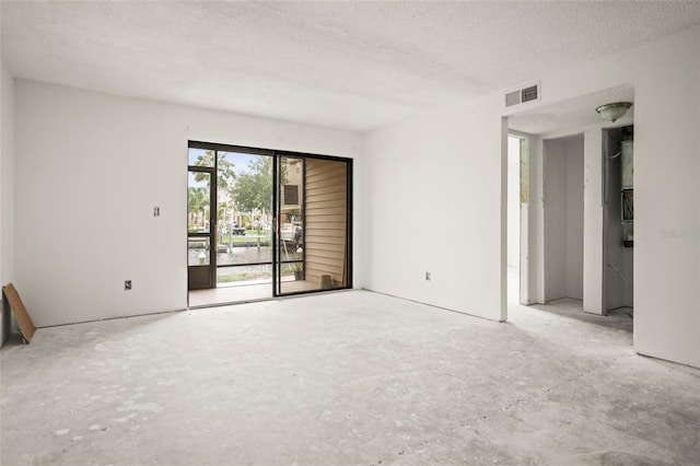 358 Moorings Cove Dr Unit 4B, Tarpon Springs, FL 34689 - spare room featuring a textured ceiling