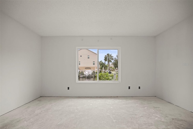 358 Moorings Cove Dr Unit 4B, Tarpon Springs, FL 34689 - empty room with a textured ceiling