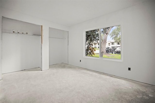 358 Moorings Cove Dr Unit 4B, Tarpon Springs, FL 34689 - unfurnished bedroom with two closets