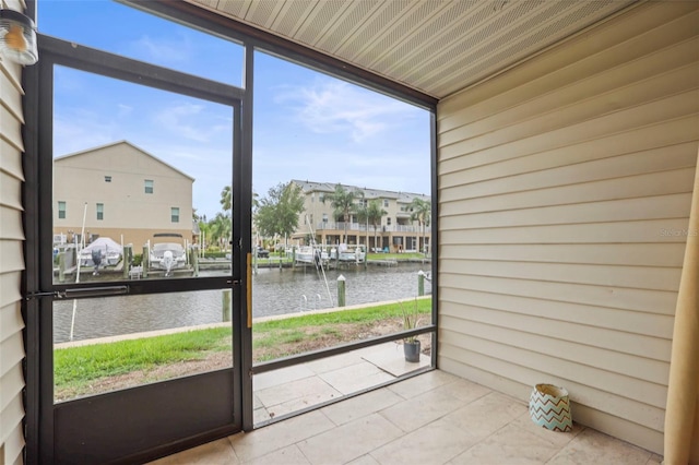 358 Moorings Cove Dr Unit 4B, Tarpon Springs, FL 34689 - unfurnished sunroom featuring a water view