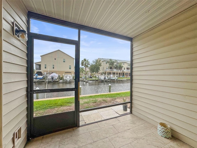 358 Moorings Cove Dr Unit 4B, Tarpon Springs, FL 34689 - unfurnished sunroom featuring a water view