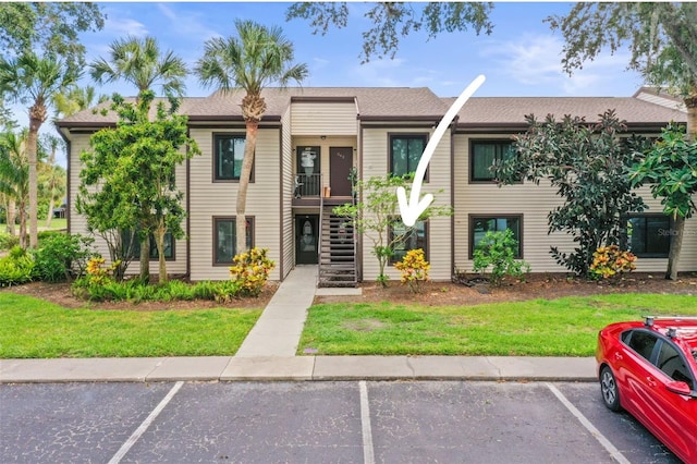 358 Moorings Cove Dr Unit 4B, Tarpon Springs, FL 34689 - view of building exterior with uncovered parking and stairway