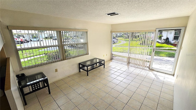 4359 Tahitian Gardens Cir Unit A, Holiday, FL 34691 - empty room with light tile patterned floors and a textured ceiling
