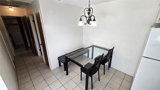 4359 Tahitian Gardens Cir Unit A, Holiday, FL 34691 - dining room featuring light tile patterned flooring, a chandelier, and a textured ceiling