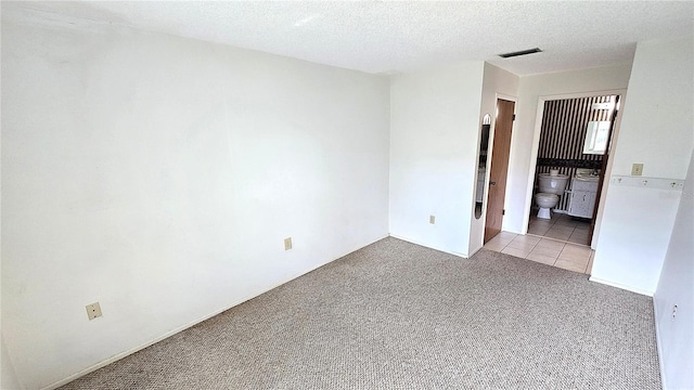 4359 Tahitian Gardens Cir Unit A, Holiday, FL 34691 - carpeted empty room featuring a textured ceiling and tile patterned flooring
