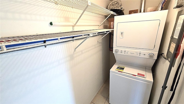 4359 Tahitian Gardens Cir Unit A, Holiday, FL 34691 - laundry area with stacked washing machine and dryer and light tile patterned floors