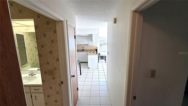 4359 Tahitian Gardens Cir Unit A, Holiday, FL 34691 - hall featuring wallpapered walls, light tile patterned flooring, and a textured ceiling