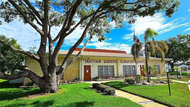 4359 Tahitian Gardens Cir Unit A, Holiday, FL 34691 - ranch-style home featuring stone siding and a front yard