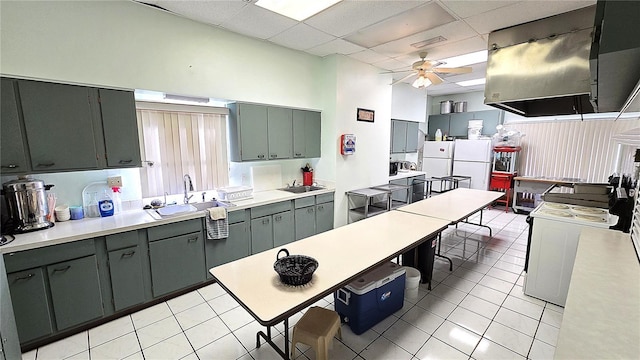 4359 Tahitian Gardens Cir Unit A, Holiday, FL 34691 - kitchen featuring ceiling fan, light tile patterned flooring, range hood, light countertops, and a drop ceiling
